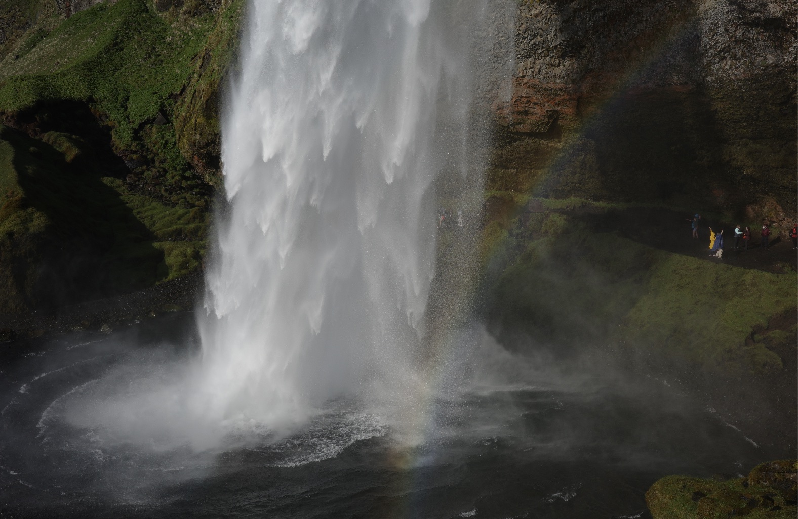 A powerful waterfall cascading into a misty pool in Iceland